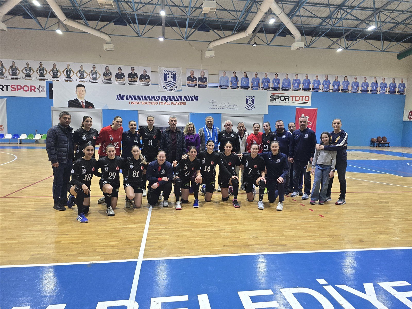 Both teams and the referees lined up on court before the match